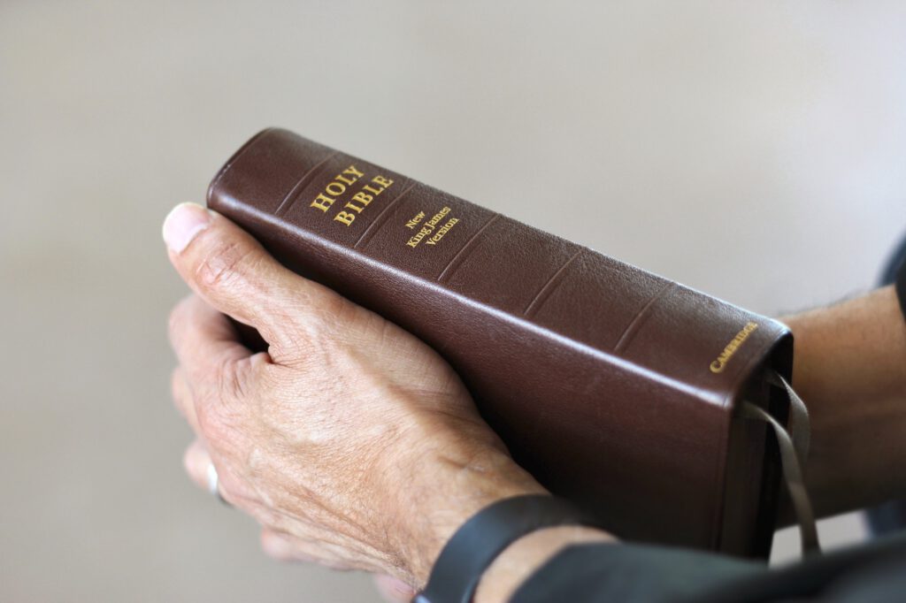 Holding a Bible.