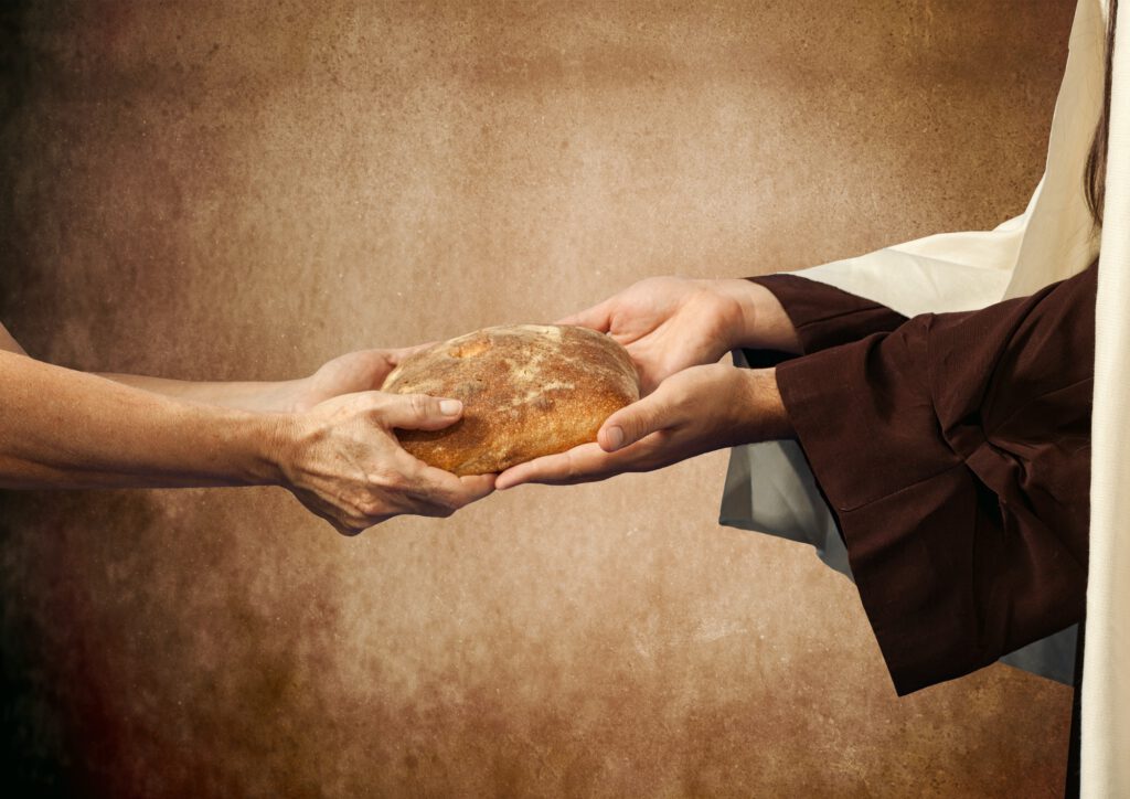 Jesus gives the bread to a beggar.